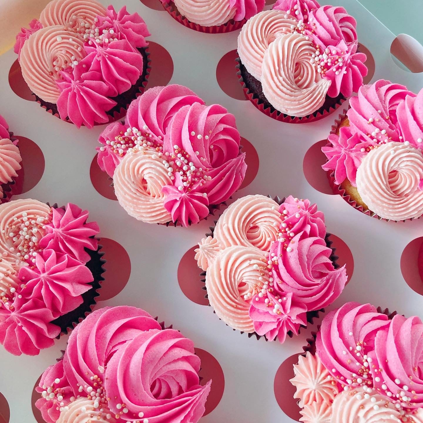 Cupcakes with pink and peach frosting with sprinkles