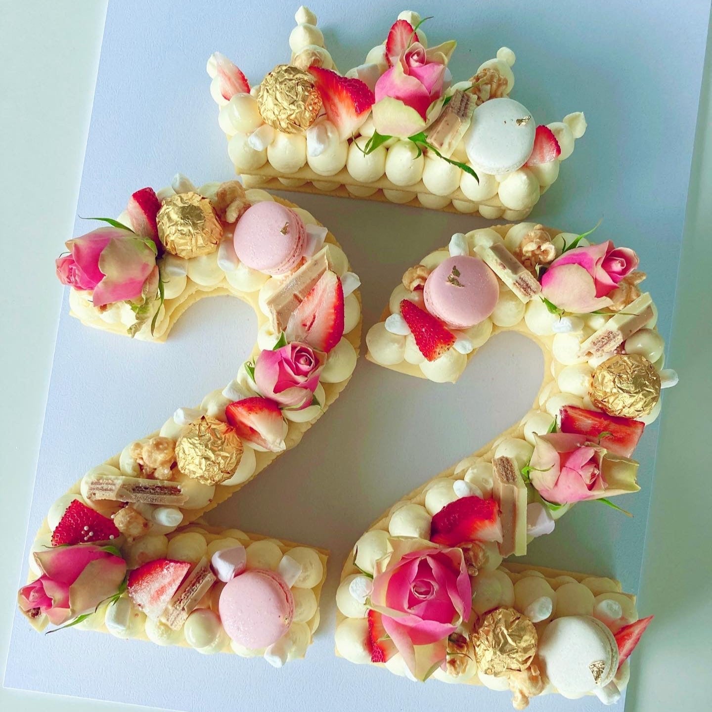 Decorative number '22' cookie cake with flowers and macarons