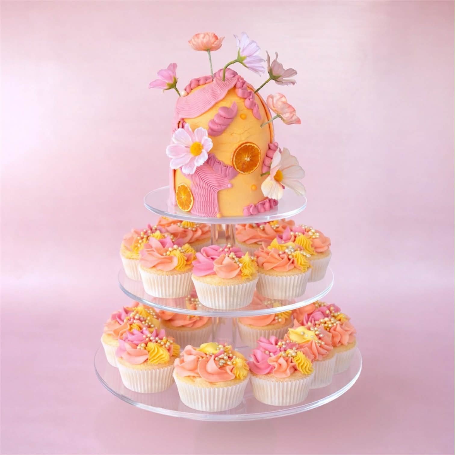 Three-tiered acrylic perspex cake stand with a decorative 4 inch cake and cupcakes 