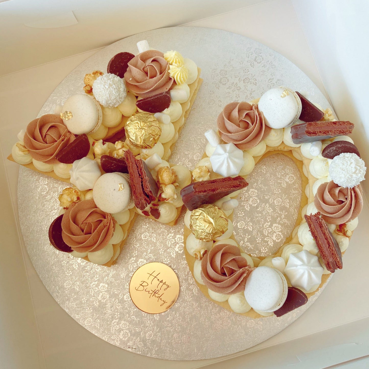 Decorative number 40 cookie birthday cake with meringue kisses and a mirror gold 'Happy Birthday' plaque 