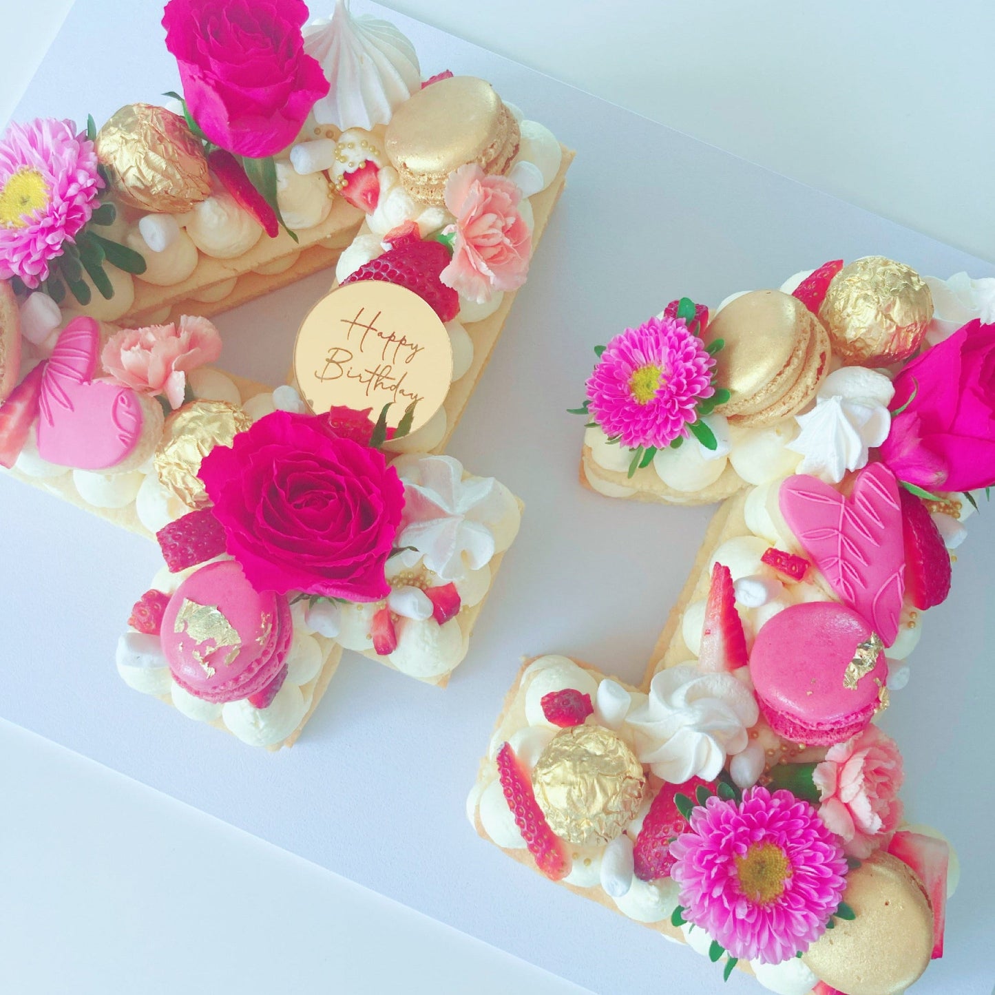 Decorative cookie cake shaped like the number 41 with flowers and gold accents.
