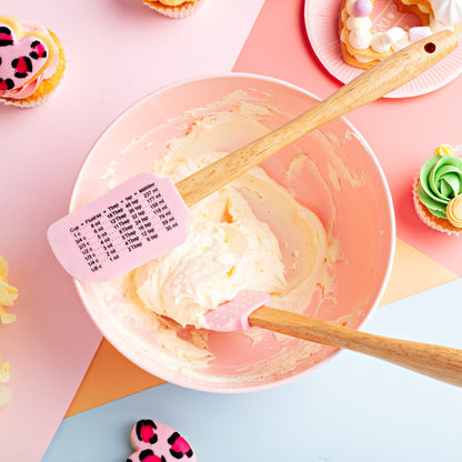 Bowl of American buttercream with a pink spatula with measurements 