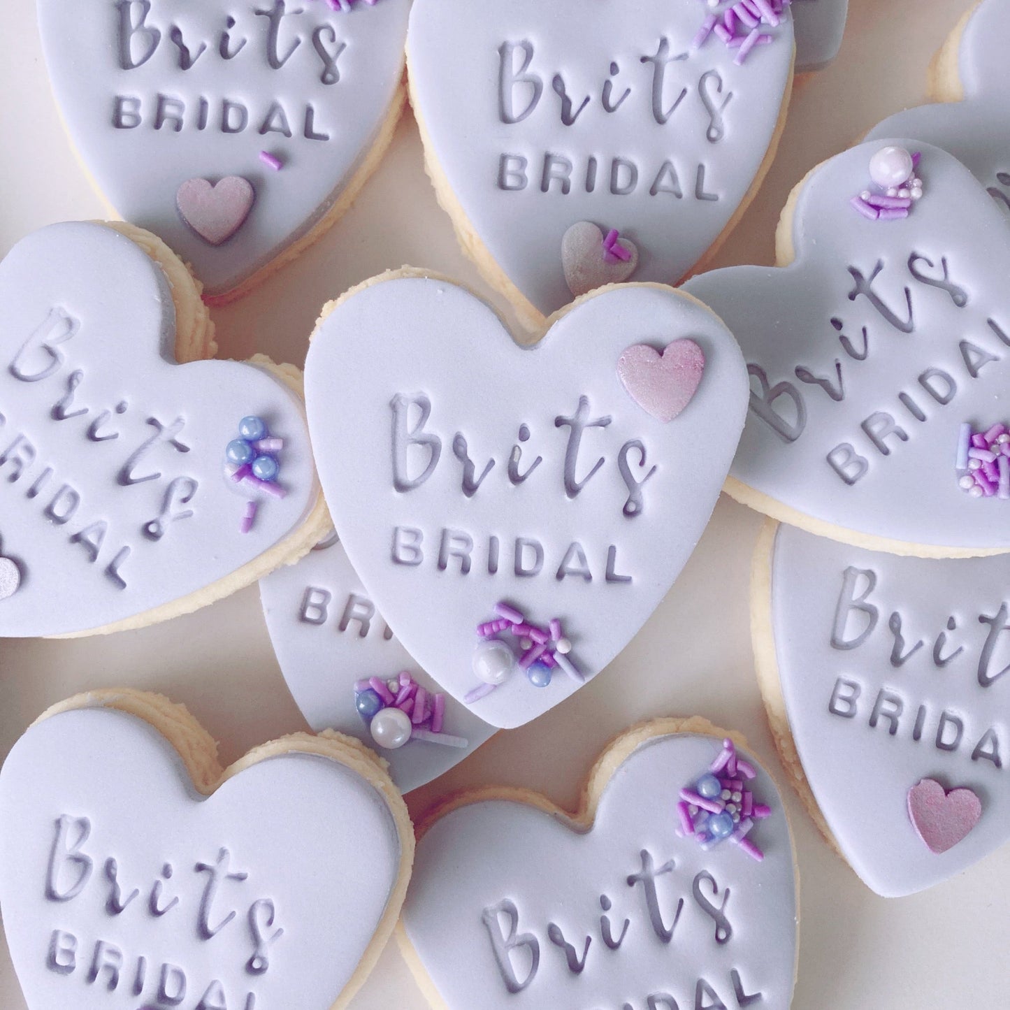 Heart-shaped fondant cookies with 'Brits Bridal' embossed 
