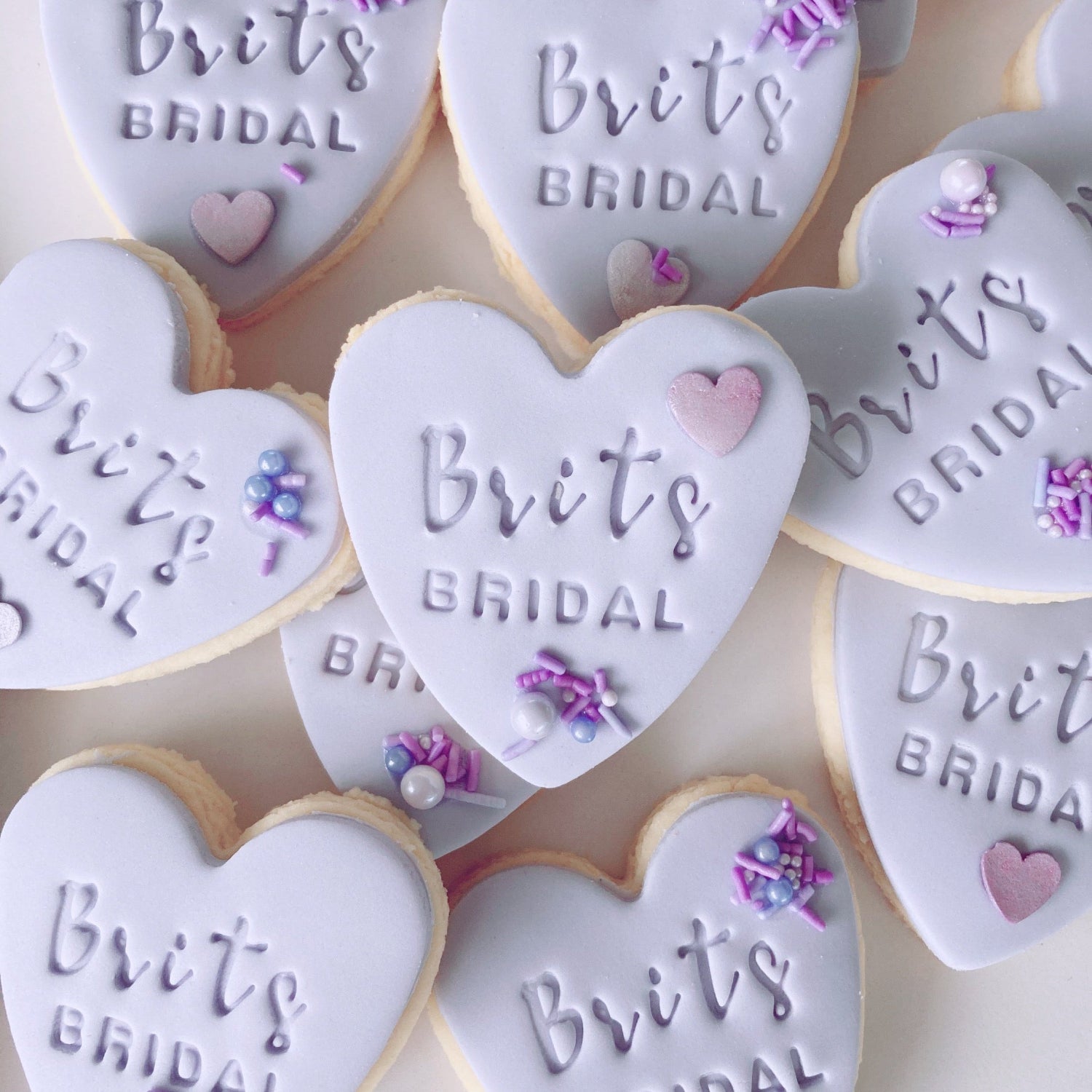 Heart-shaped fondant cookies with 'Brits Bridal' embossed 