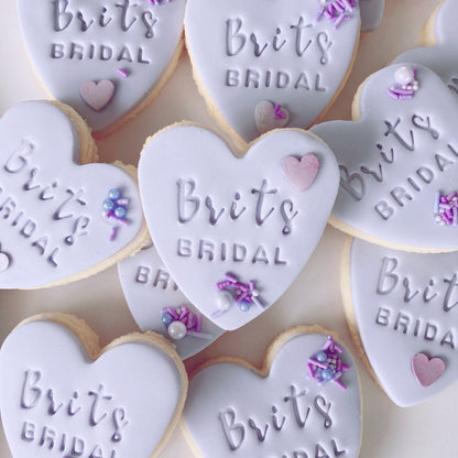 Heart-shaped fondant cookies with 'Brits Bridal' embossed 