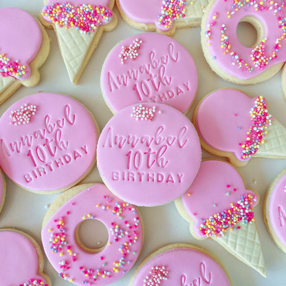Pink birthday cookies with 'Happy 10th Birthday' text and sprinkles on a white background