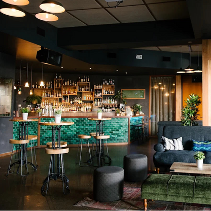 Modern bar Loft in West End with dark interior, green accents, and a cozy atmosphere for baking class