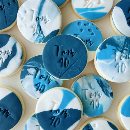 Decorative almond cookies with blue and white fondant with custom text