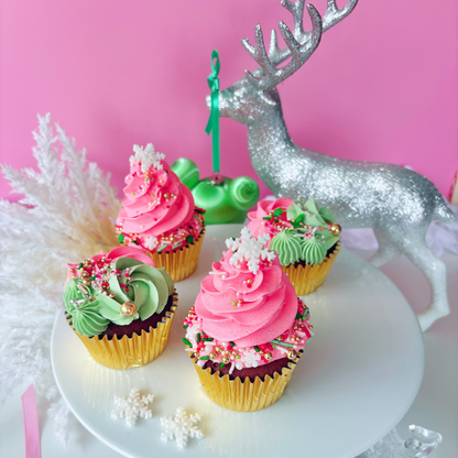 Christmas festive cupcakes with pink & green buttercream with silver Christmas decoration.