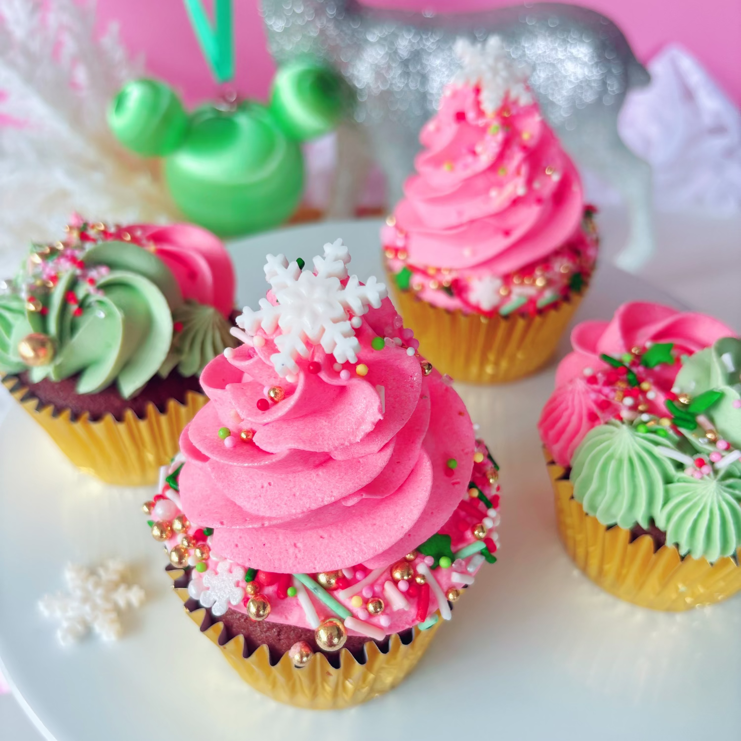 Festive cupcakes with pink and green buttercream and Christmas sprinkles