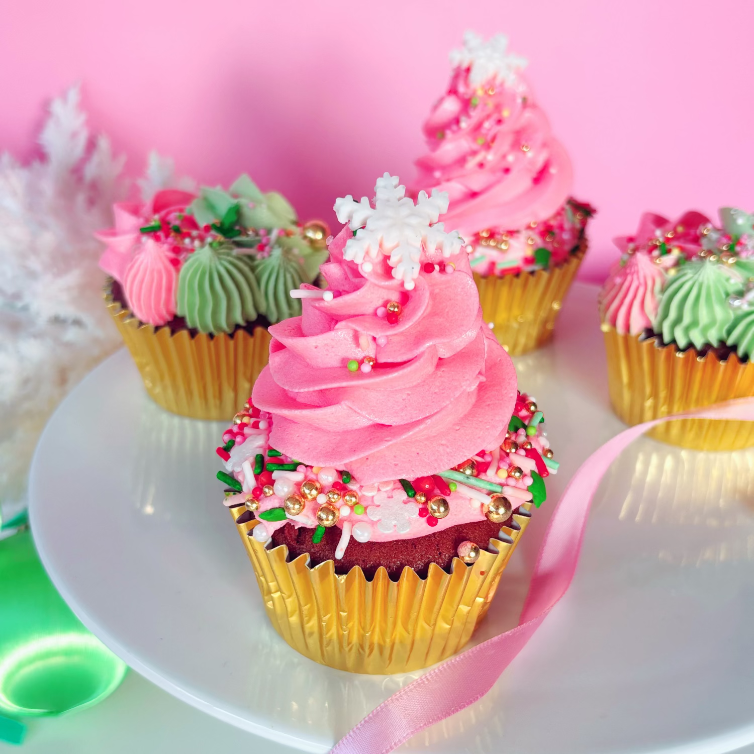 Decorative festive cupcakes with pink and green frosting.