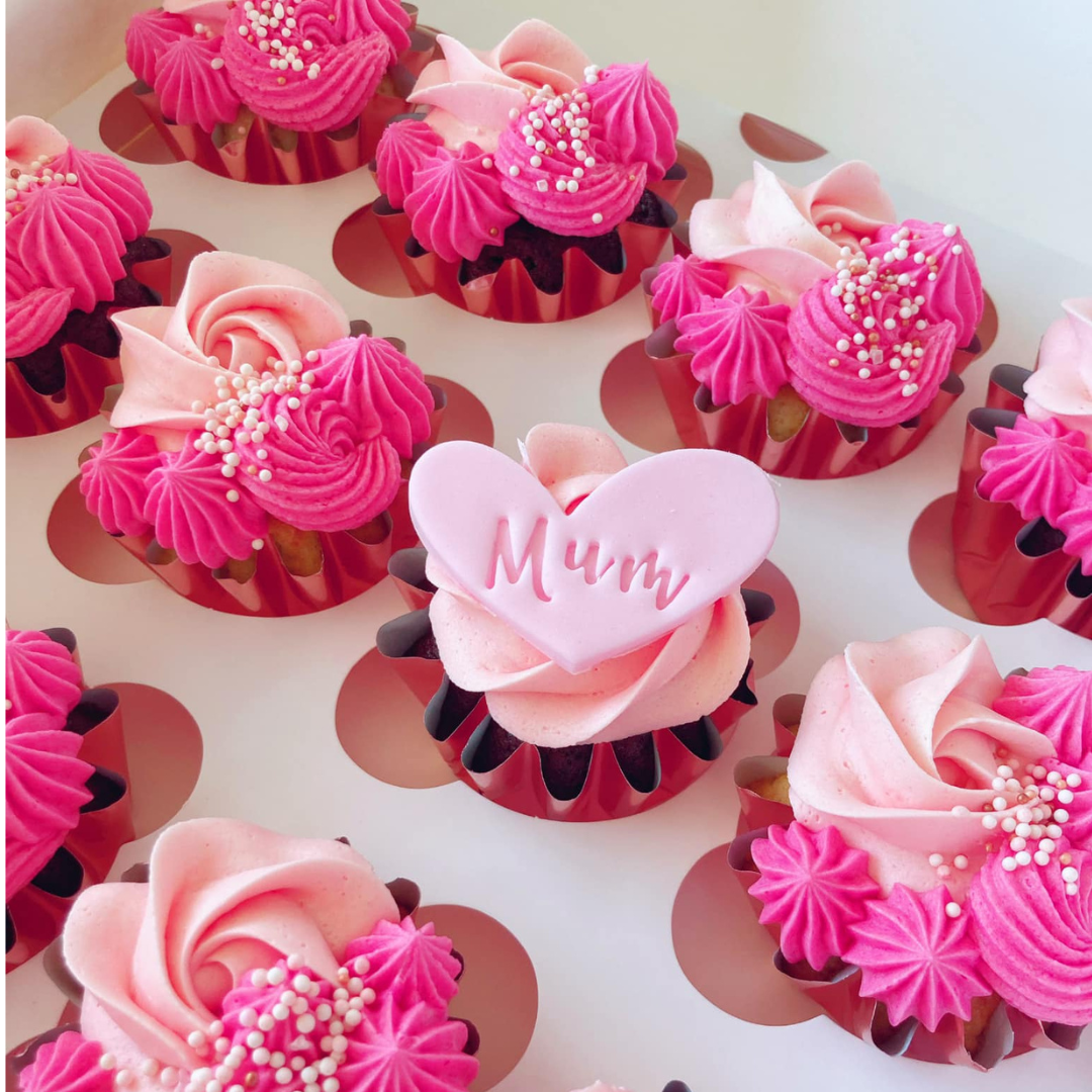 Decorative cupcakes with pink frosting and 'Mum' heart topper