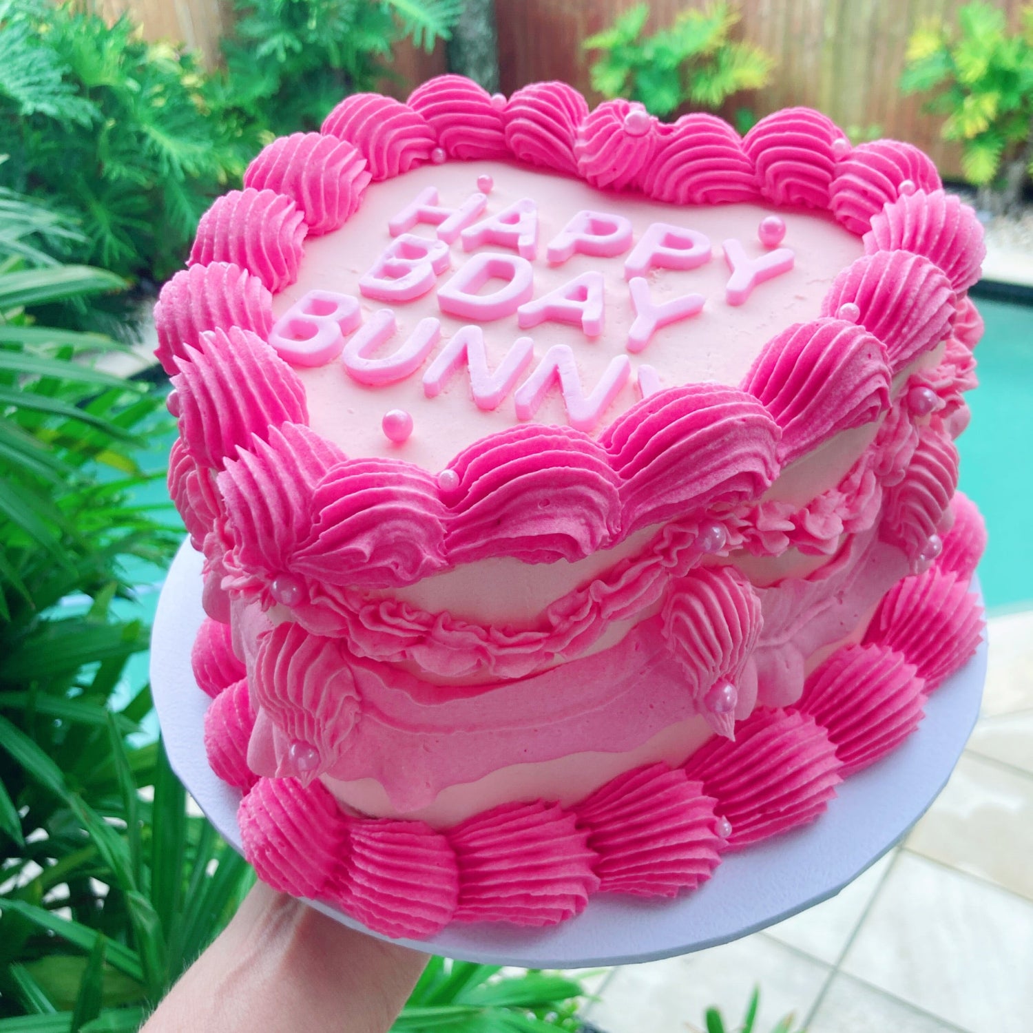 Pink 8 inch birthday cake with 'Happy Birthday' fondant letters with vintage piping with buttercream